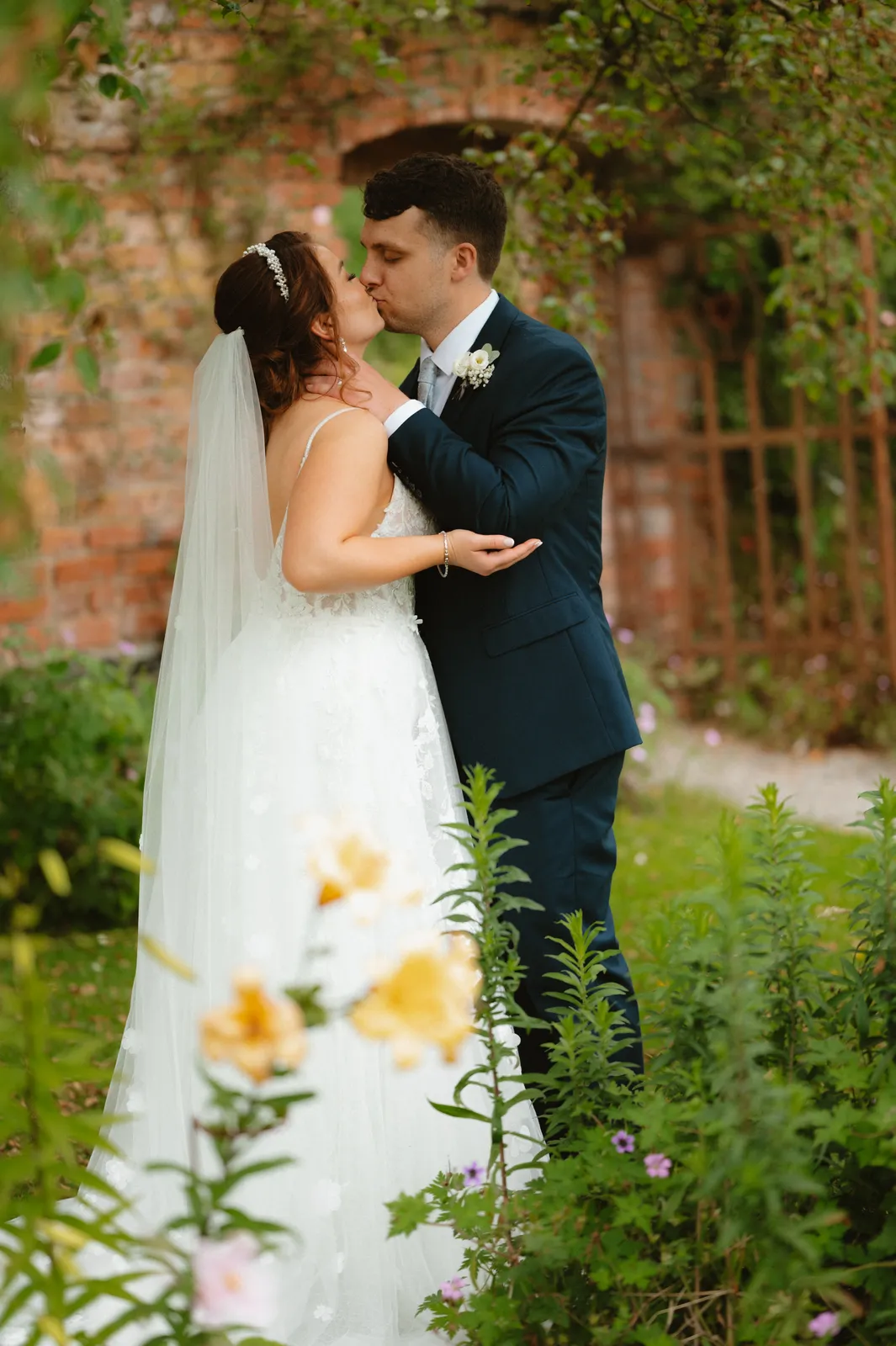 Claire and Will beneath a garden arch