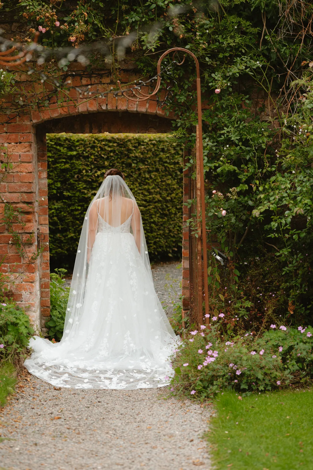 Claire beneath a brick garden doorway