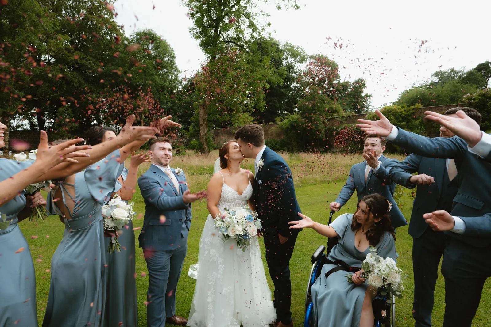 Guests throw confetti around the couple
