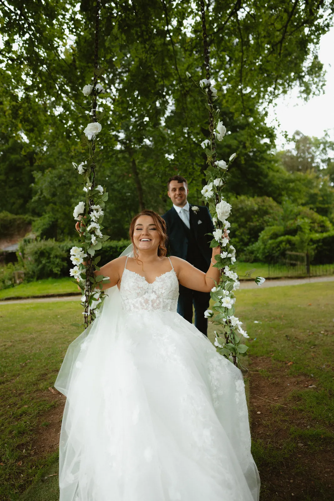 Claire on a flower-trimmed swing with Will