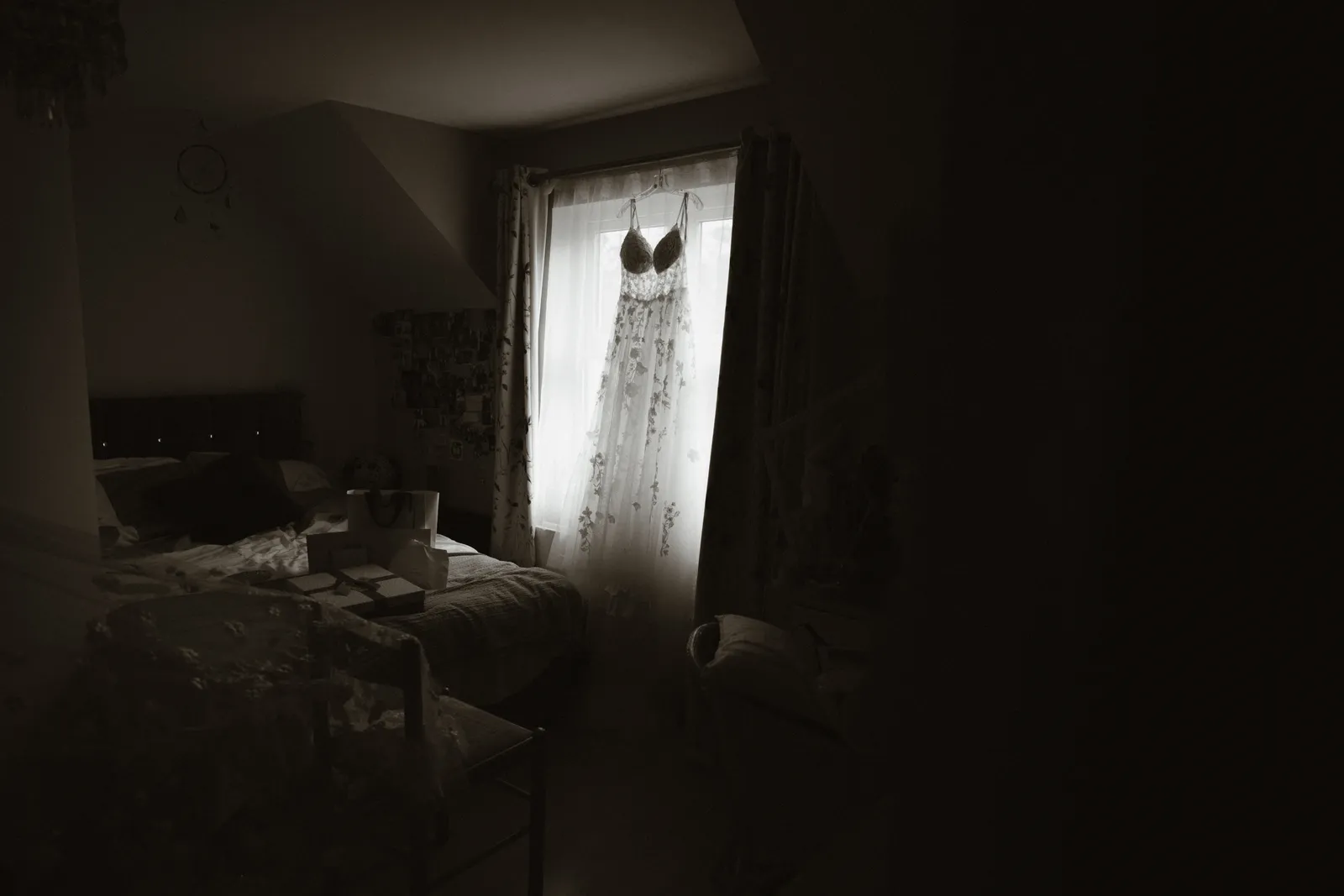 Wedding dress hanging at a window