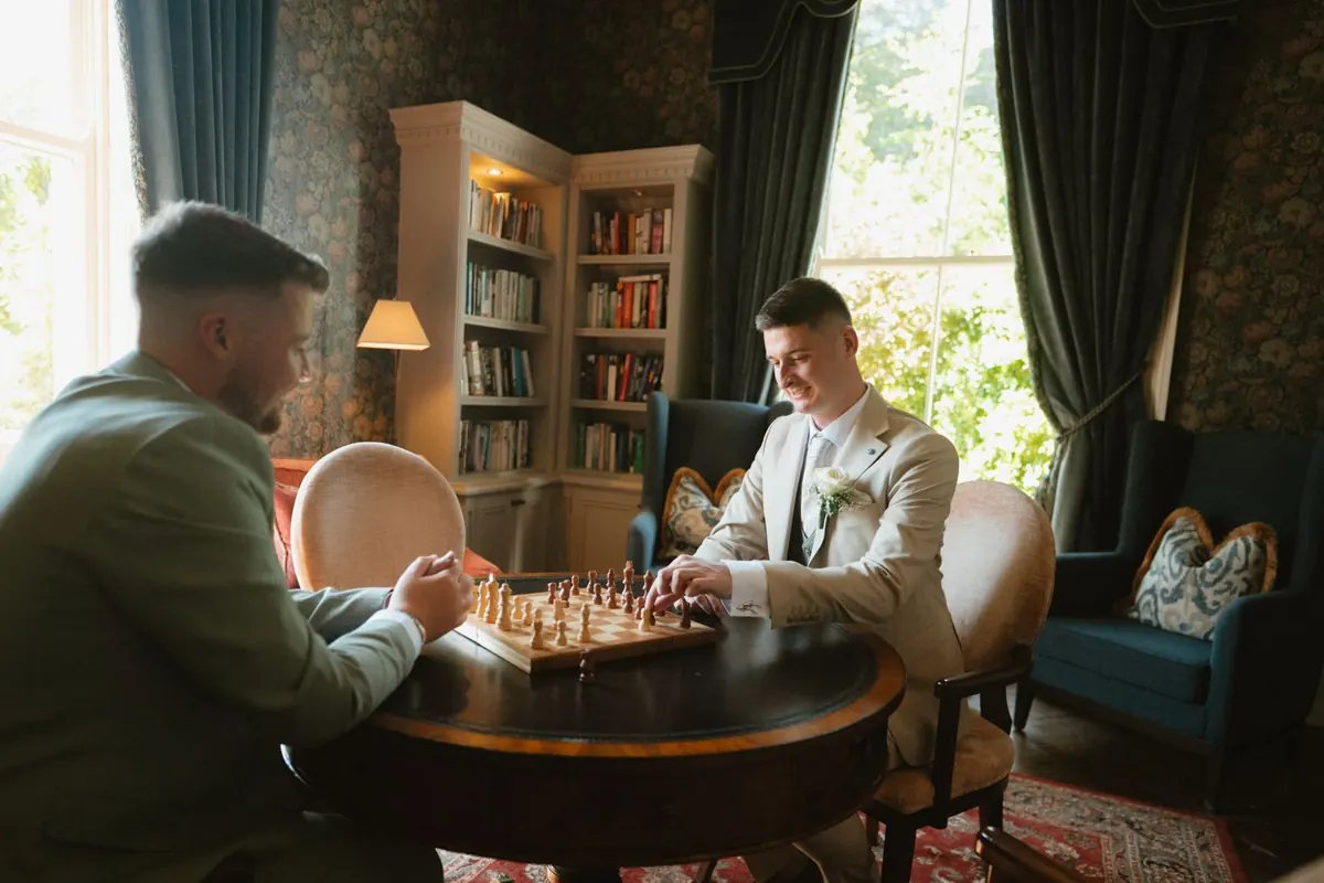 The grooms playing chess at a round table