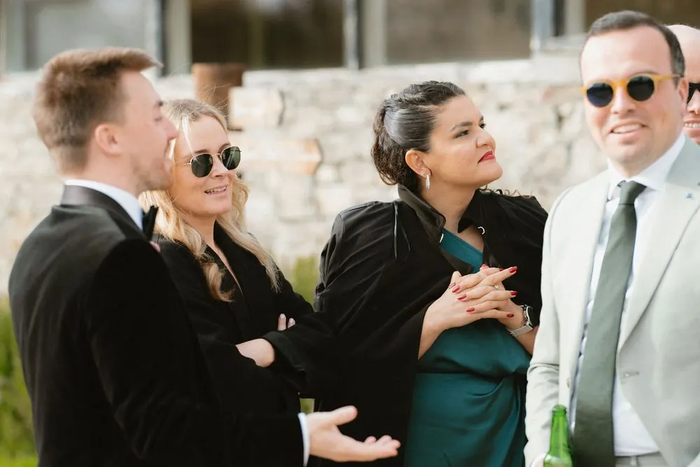 Group of elegantly dressed guests socializing outdoors at a formal event, wearing sunglasses and smart attire at Boyne Hill House Estate