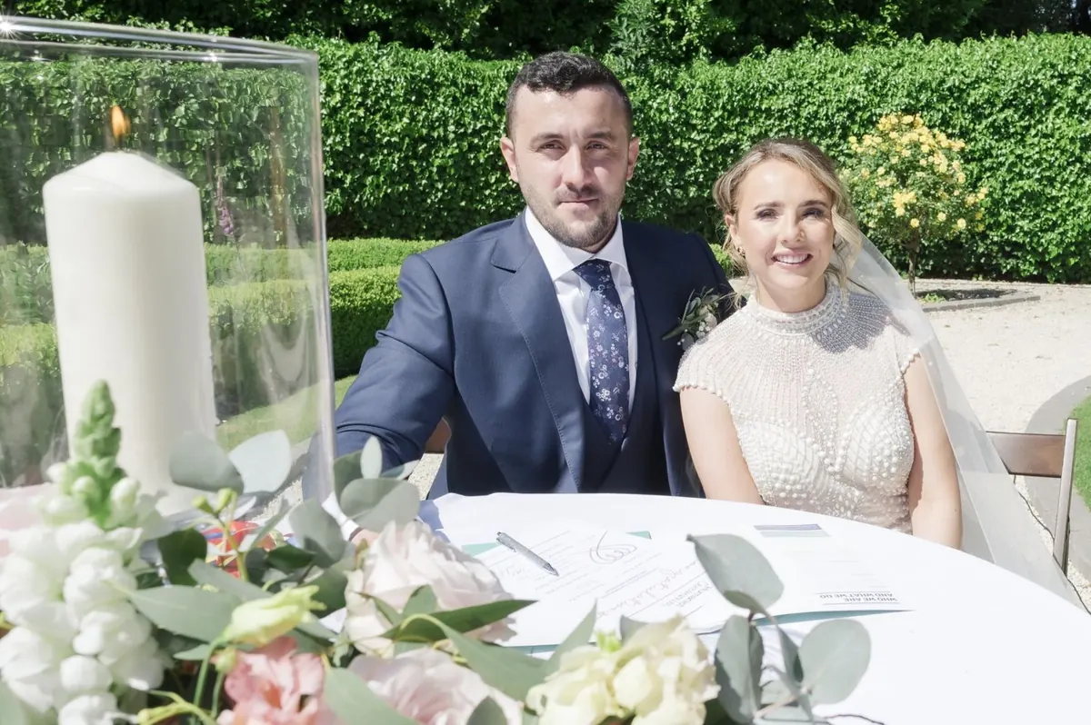 Steph and Ramon seated at the ceremony table