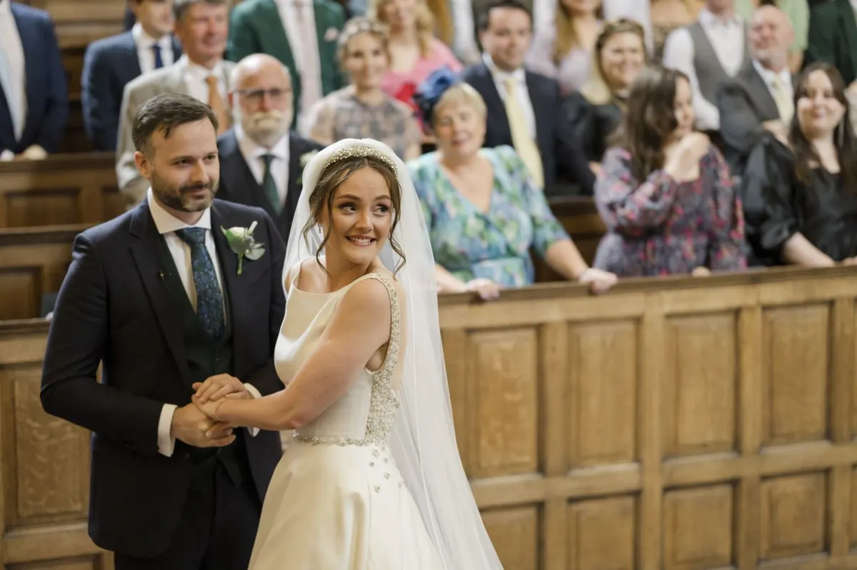 Carole and Stephen turning towards their guests in the chapel