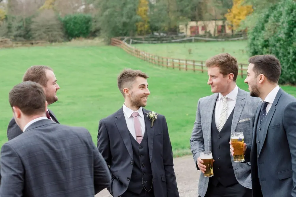 Groomsmen in grey suits chatting outdoors at Boyne Hill House Estate, wedding venue in Co.Meath