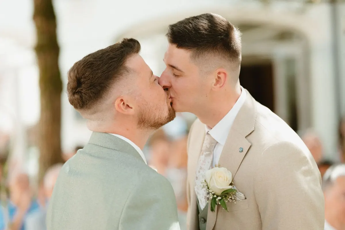 The grooms kissing during their ceremony