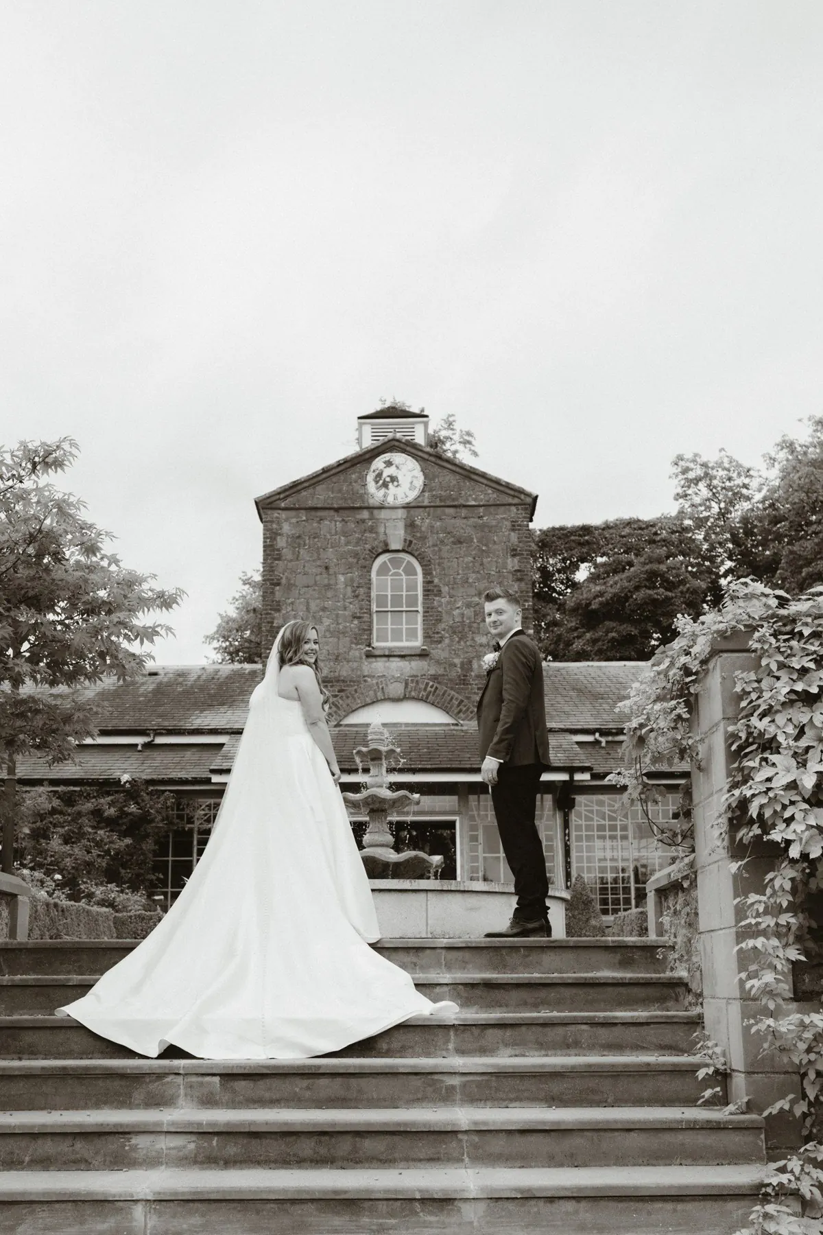 Black and white view of the couple on the stone garden steps
