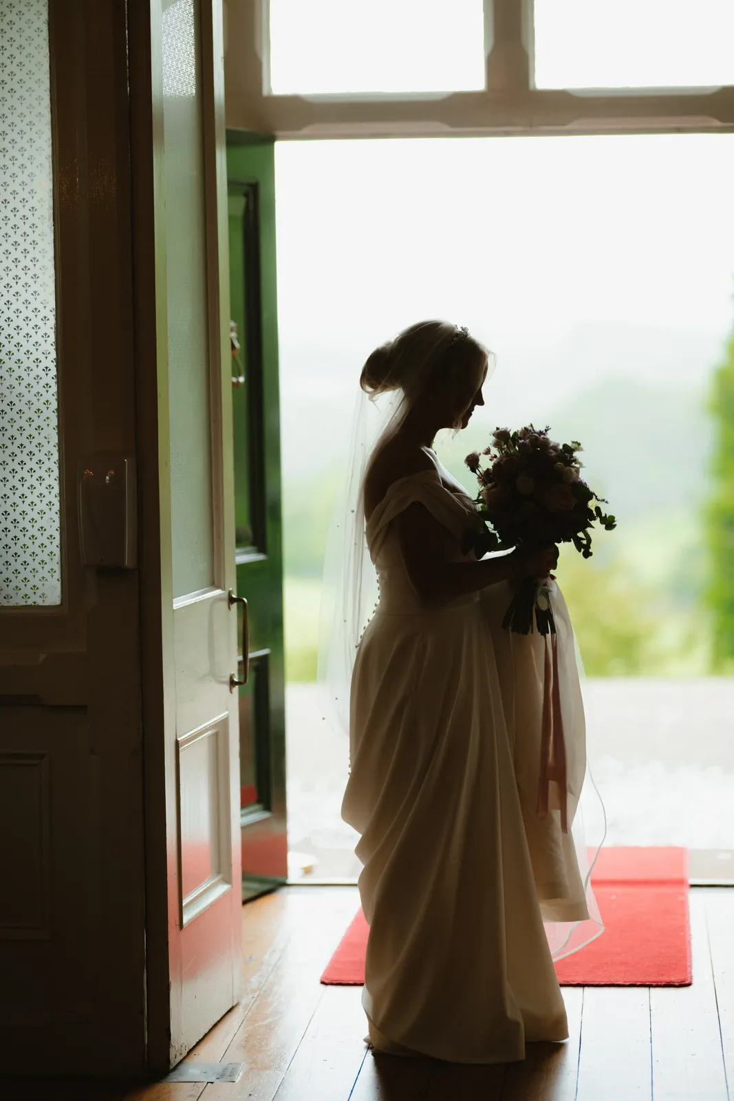 Emma silhouetted at the open door