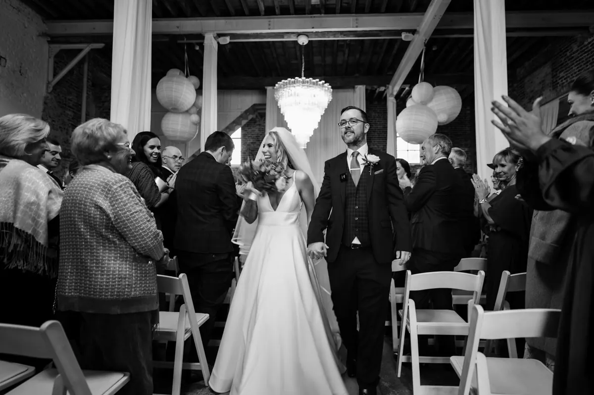 The couple walking back through their guests after the ceremony