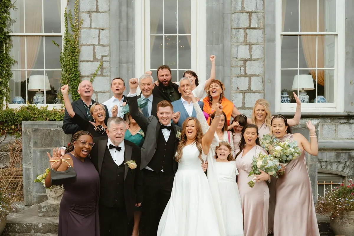 A lively group photograph outside the house