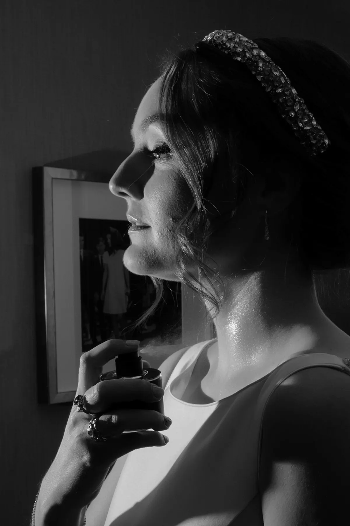 A quiet black-and-white portrait of Carole beside a window.