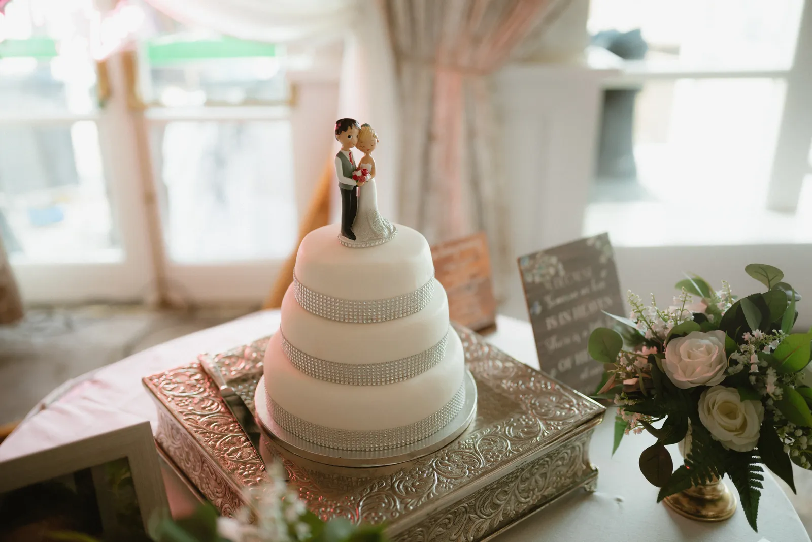 Wedding cake with a small couple topper