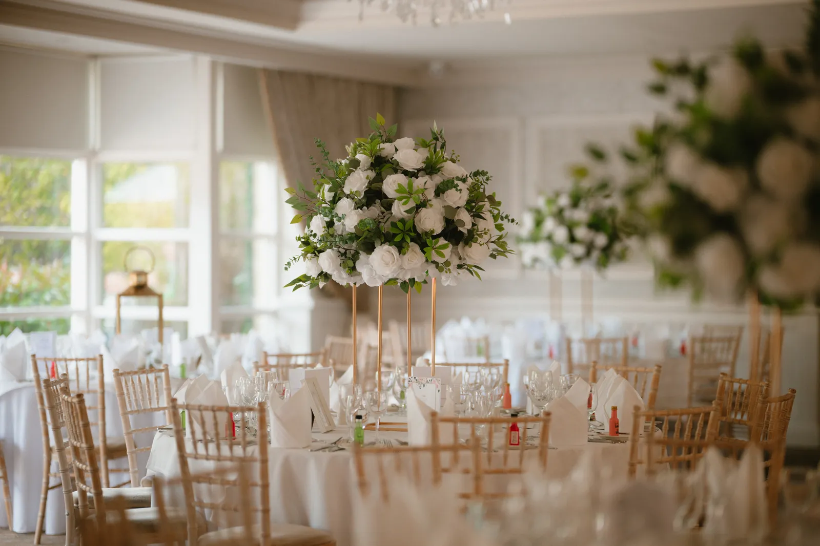 The reception room set with tall white flowers