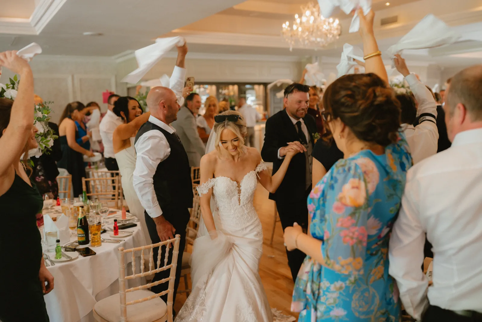 Hazel celebrating as guests wave napkins