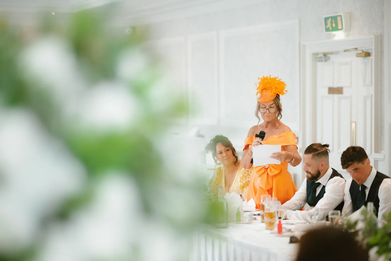 A guest in orange giving a speech