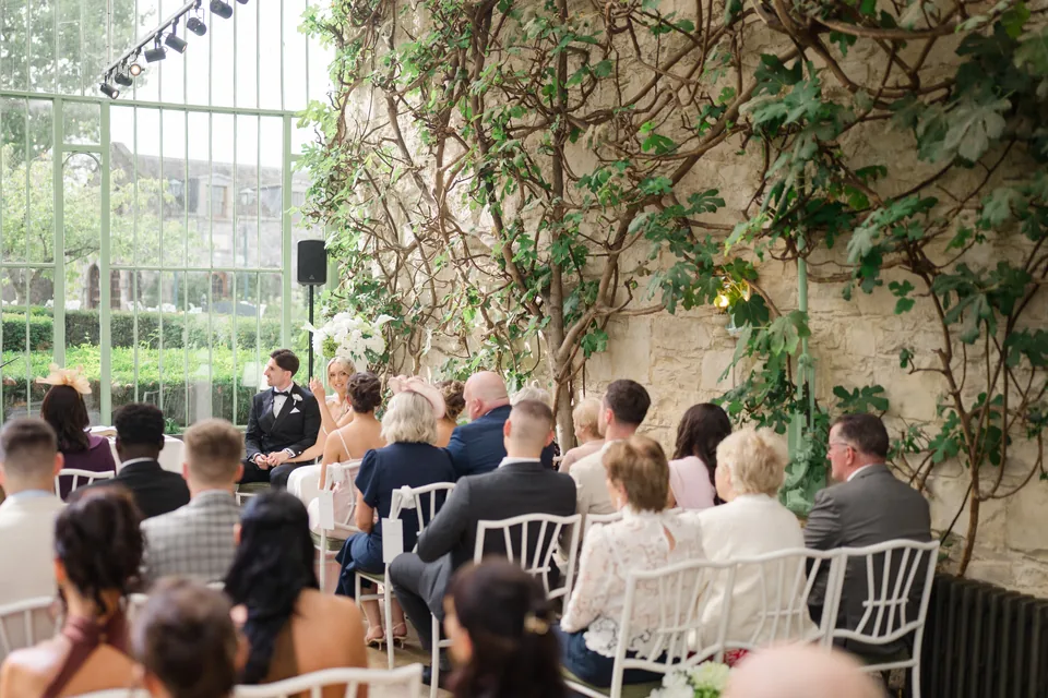 A broad view of the conservatory ceremony and greenery.