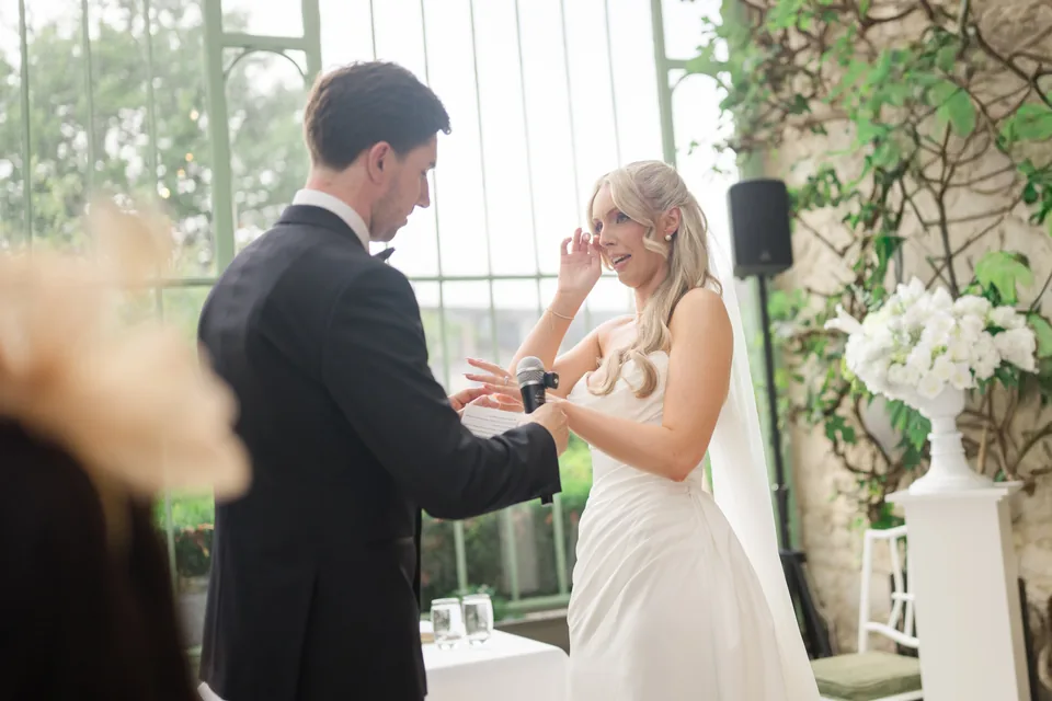 Holly wipes away a tear while Jay smiles during the ceremony.