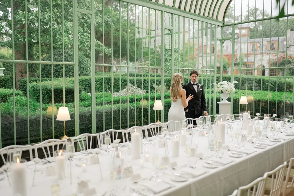 The couple and long table establish the conservatory dining space.