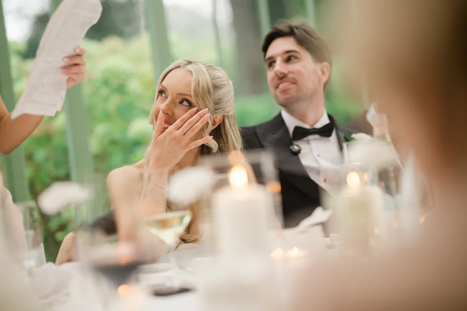 Holly wipes away tears while Jay smiles during the speeches.