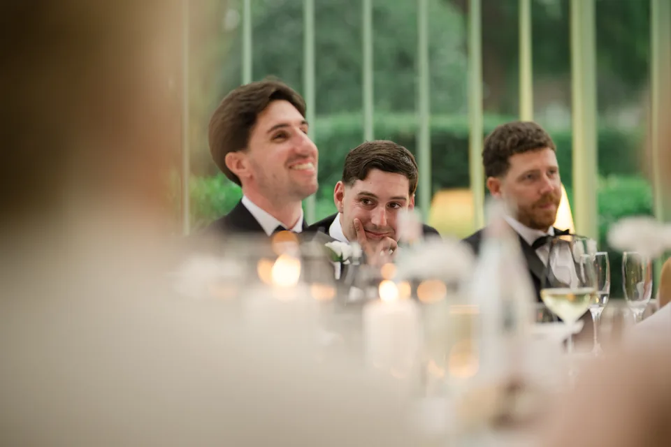 Jay smiles upward while listening to a speech.
