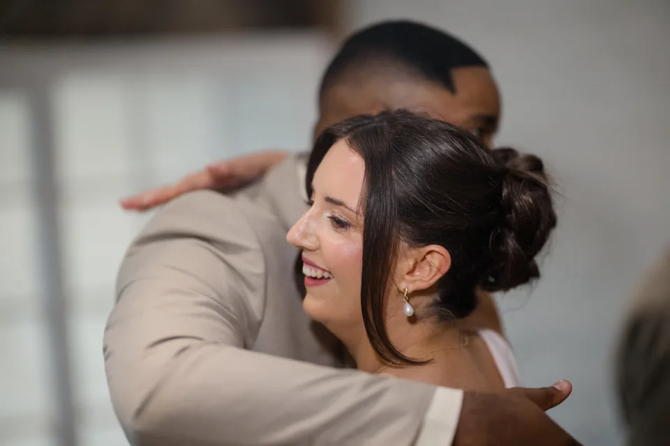 A close embrace between wedding guests.