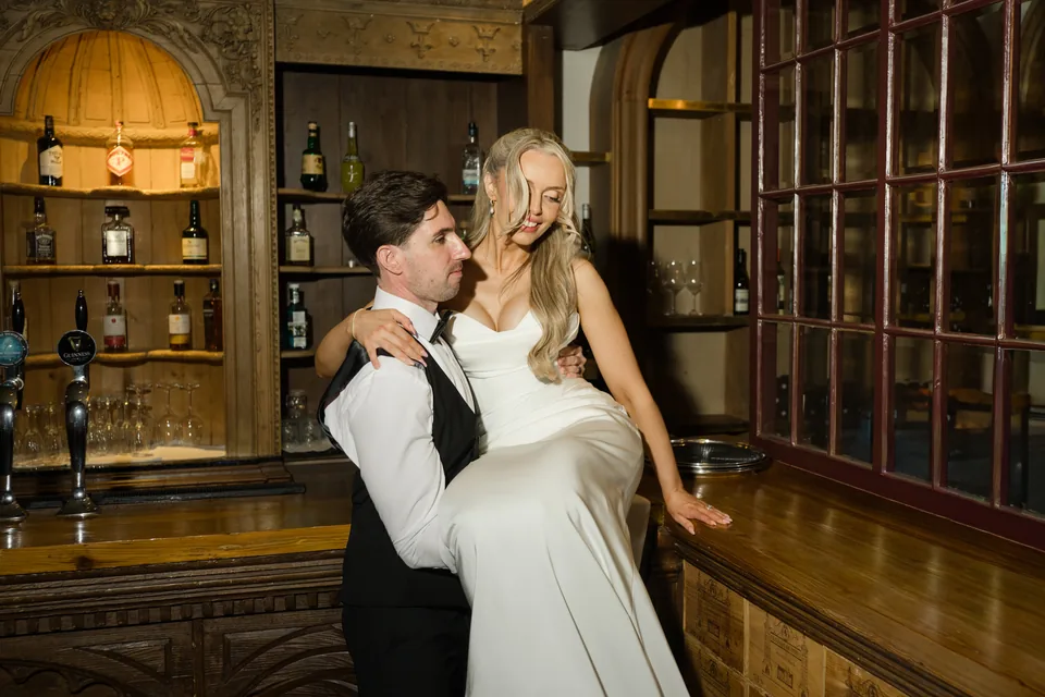 A close couple portrait against the warmly lit room.