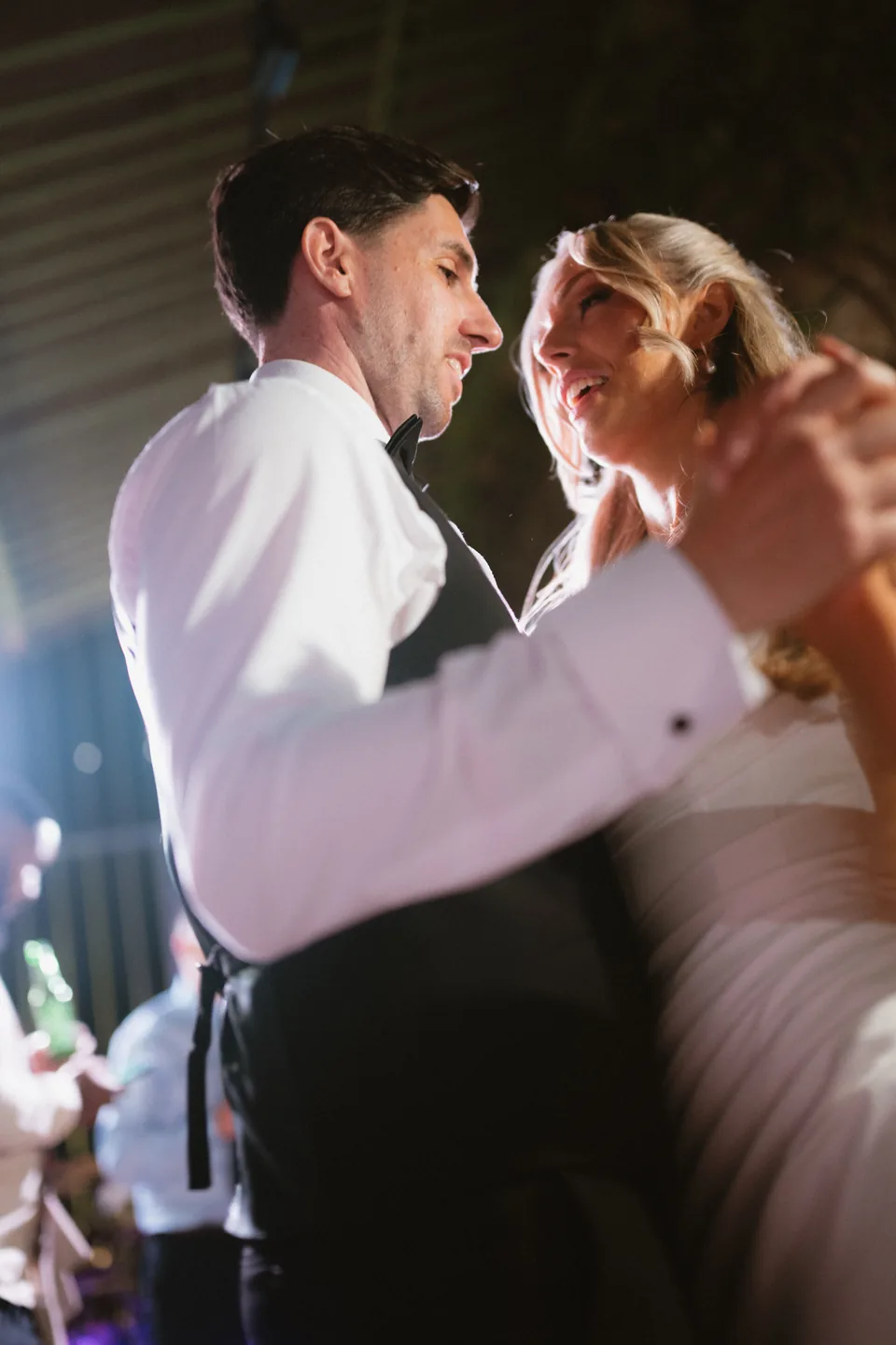 Holly and Jay share their first dance in a darkened room.