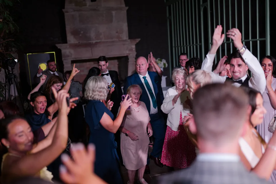 Guests raise their arms together as the party gets going.