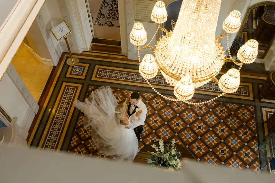 Ieva and Darren beneath the chandelier at Manor House Country Hotel