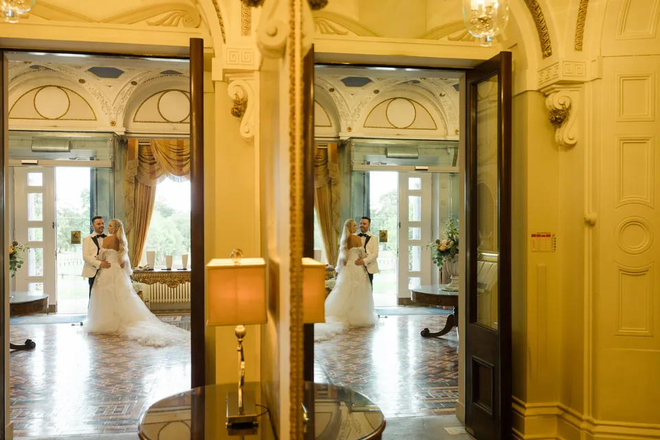 Ieva and Darren reflected in the mirrored hotel interior