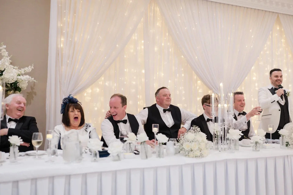 Guests laughing during the speeches at Ieva and Darren’s reception