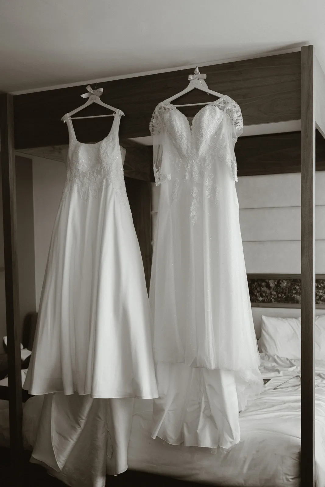 Two wedding dresses hanging together
