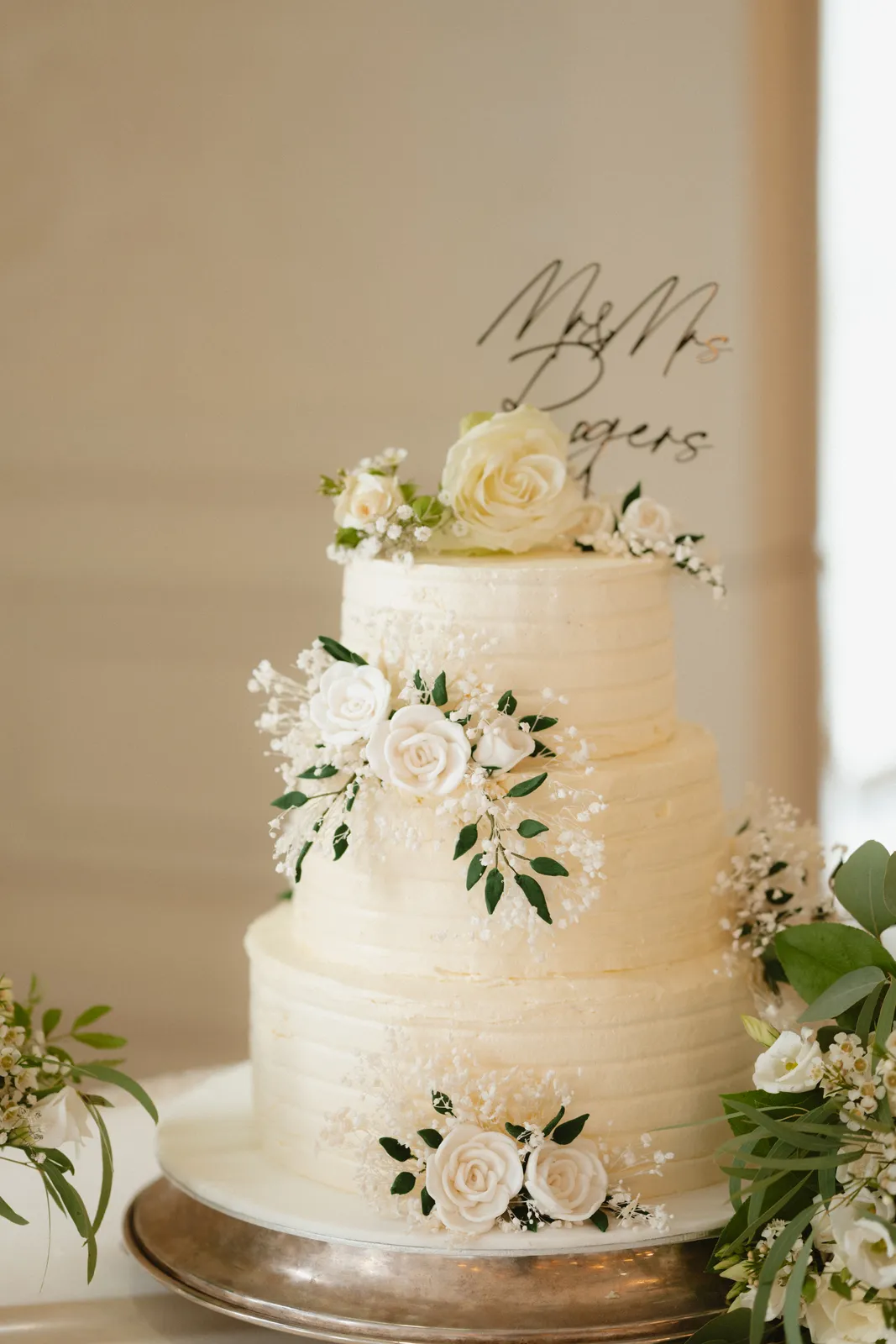 Wedding cake decorated with pale flowers