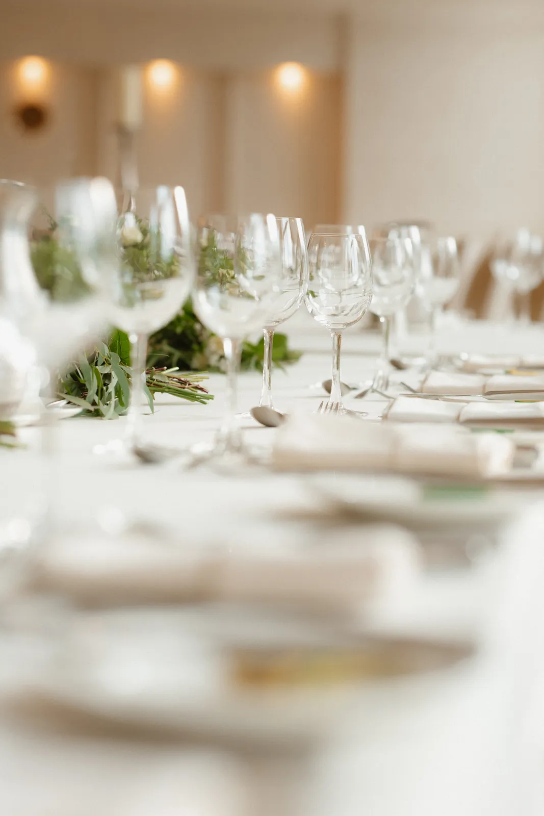 Wine glasses and white table linen arranged for the reception at the Four Seasons Carlingford.