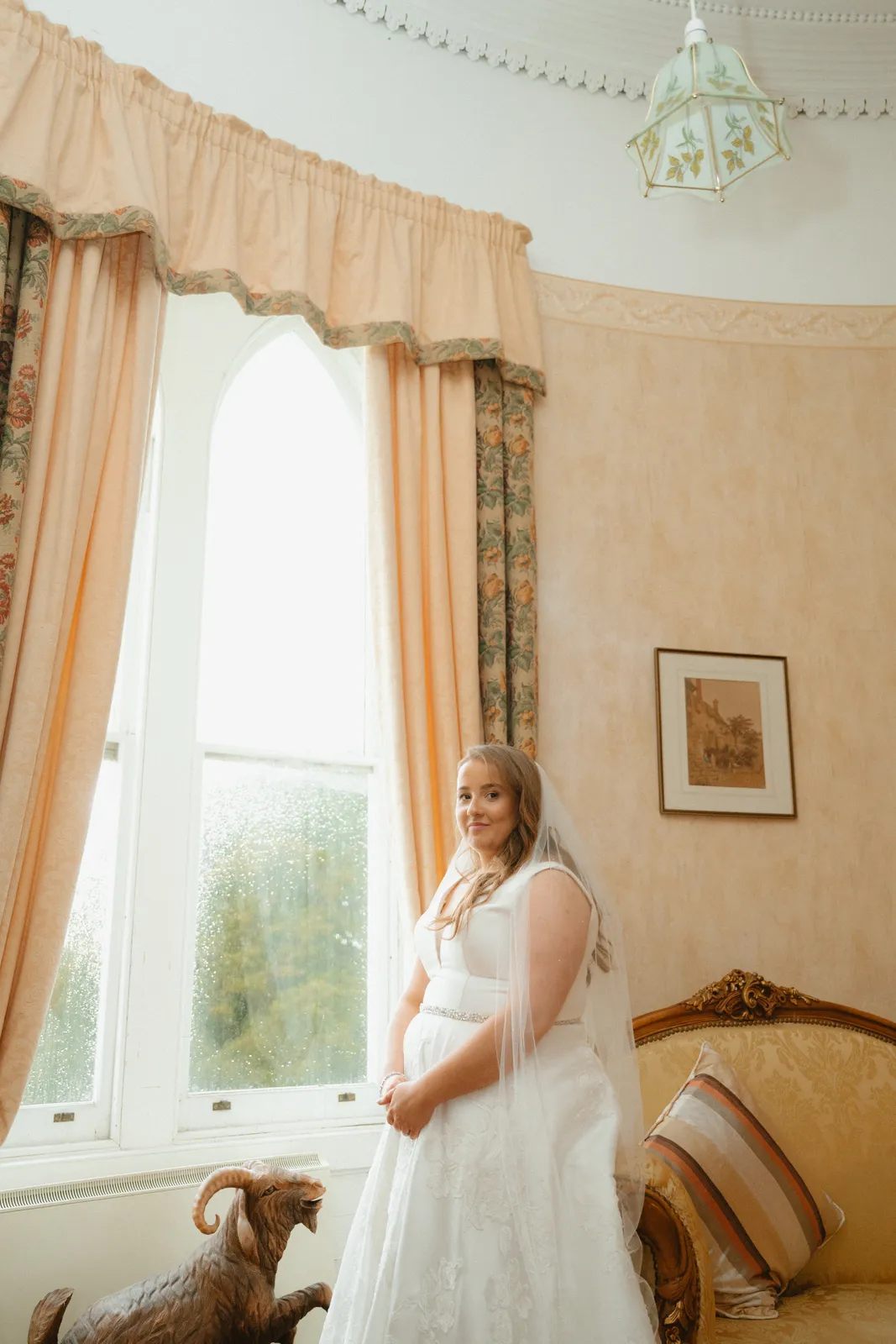 Leah beside a tall window