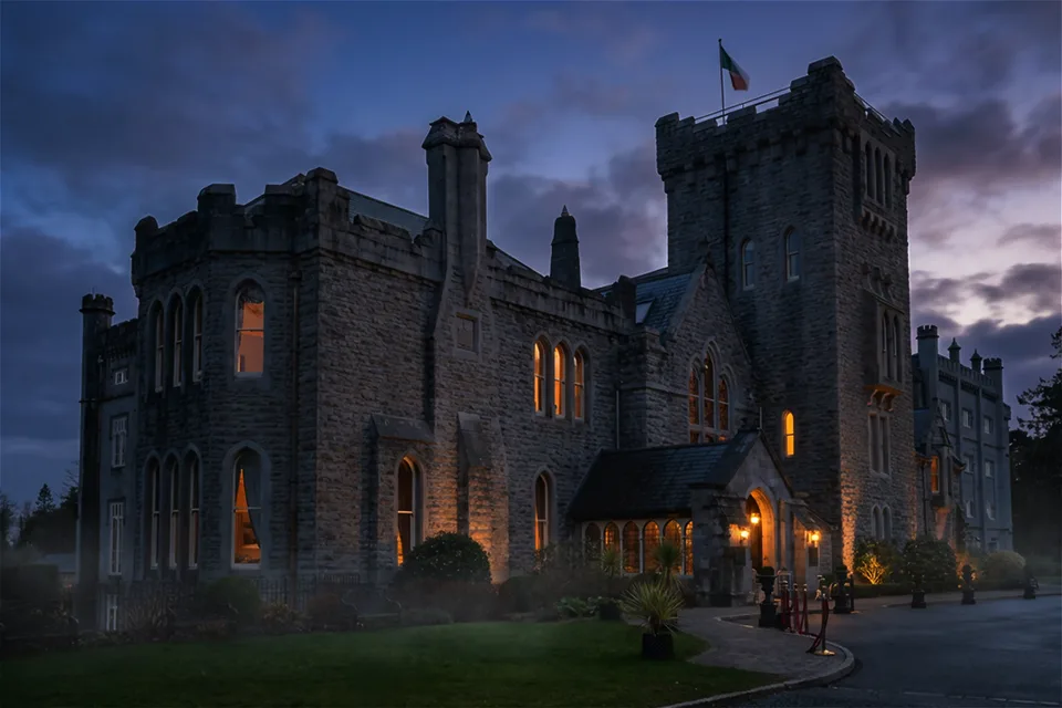 Kilronan Castle illuminated beneath a blue evening sky in County Roscommon.