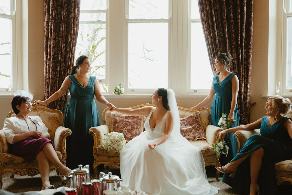 Lynsey and her bridesmaids gathered around the sitting area in the castle bedroom.