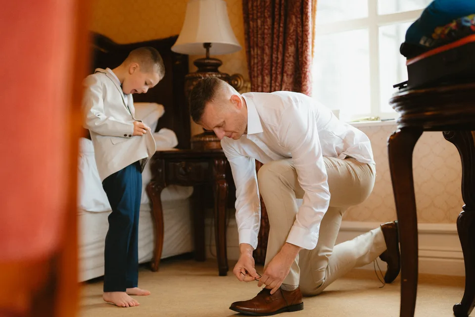 Jamie getting help with his tie before the wedding.