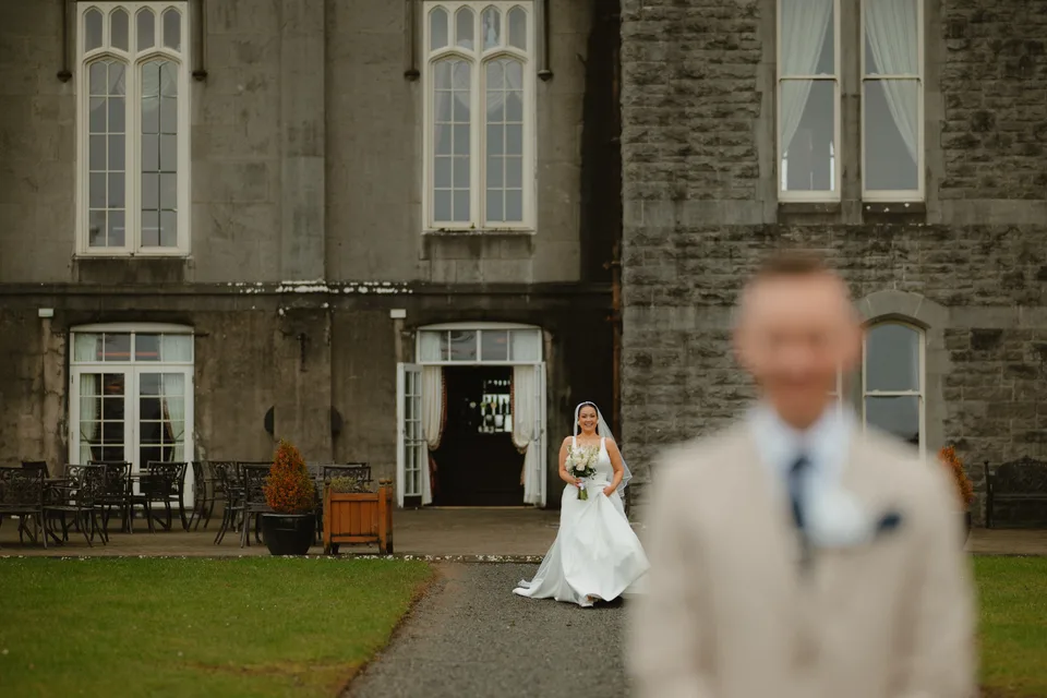 Lynsey approaching Kilronan Castle with a young attendant in the foreground.