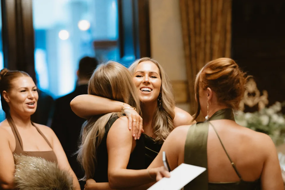 A warm embrace among the guests before the wedding ceremony.