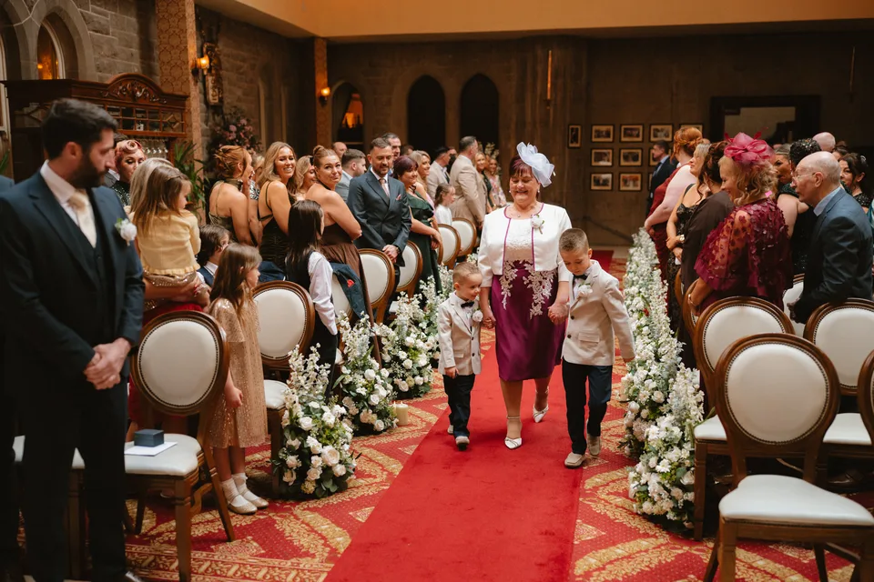 The young wedding attendants making their way along the aisle.