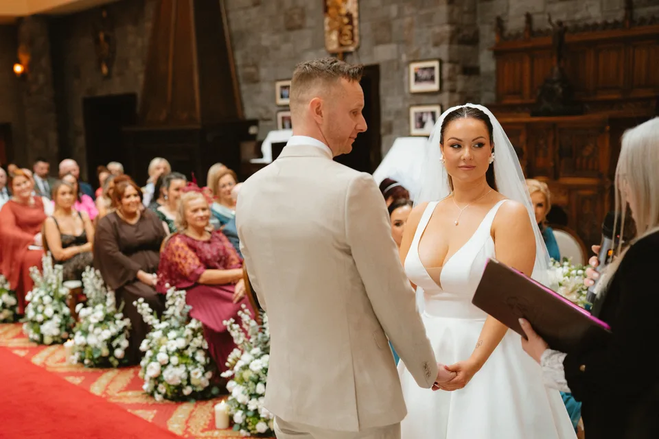 Lynsey laughing beside Jamie during their wedding ceremony.