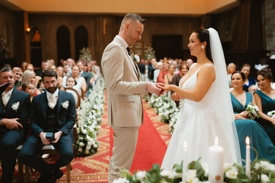Lynsey and Jamie exchanging rings in front of their guests.