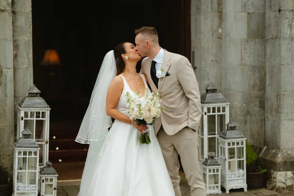 Lynsey and Jamie sharing a kiss at the stone doorway.