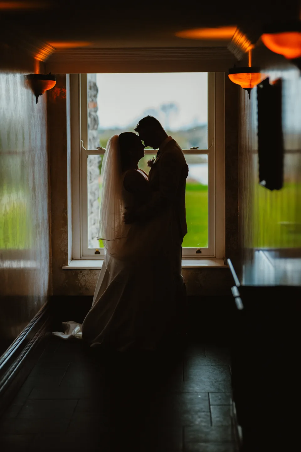 A silhouette of Lynsey and Jamie in the castle doorway.