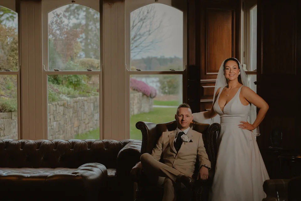 Lynsey and Jamie framed by the castle windows and dark timber panelling.