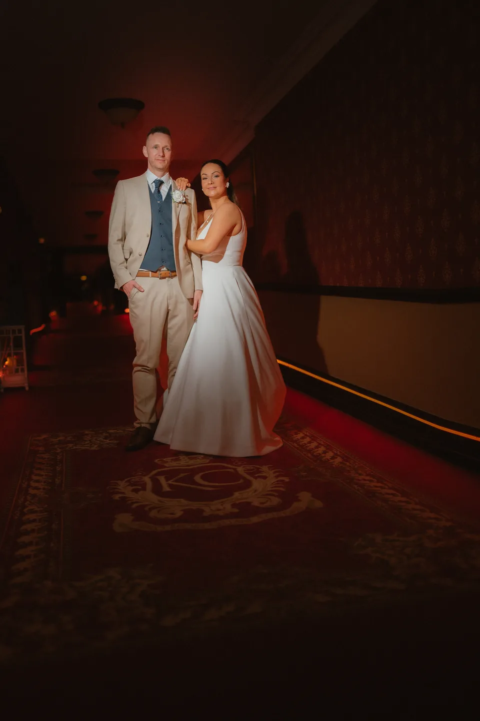 Lynsey and Jamie together in a warmly lit castle interior.