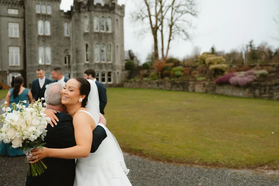 Lynsey embracing a guest on the lawn outside the castle.