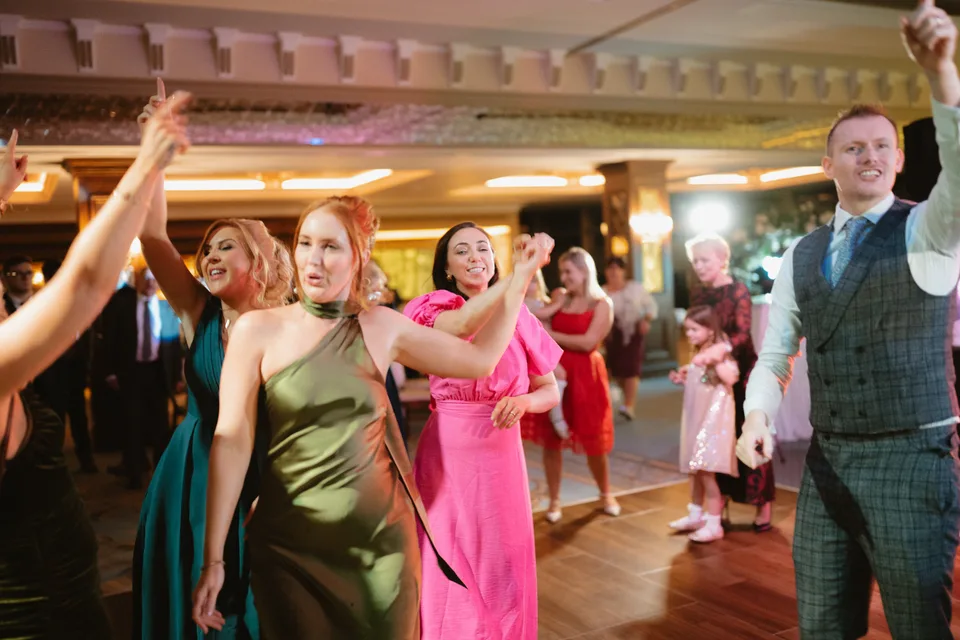 Family and friends raising their hands on the dance floor.